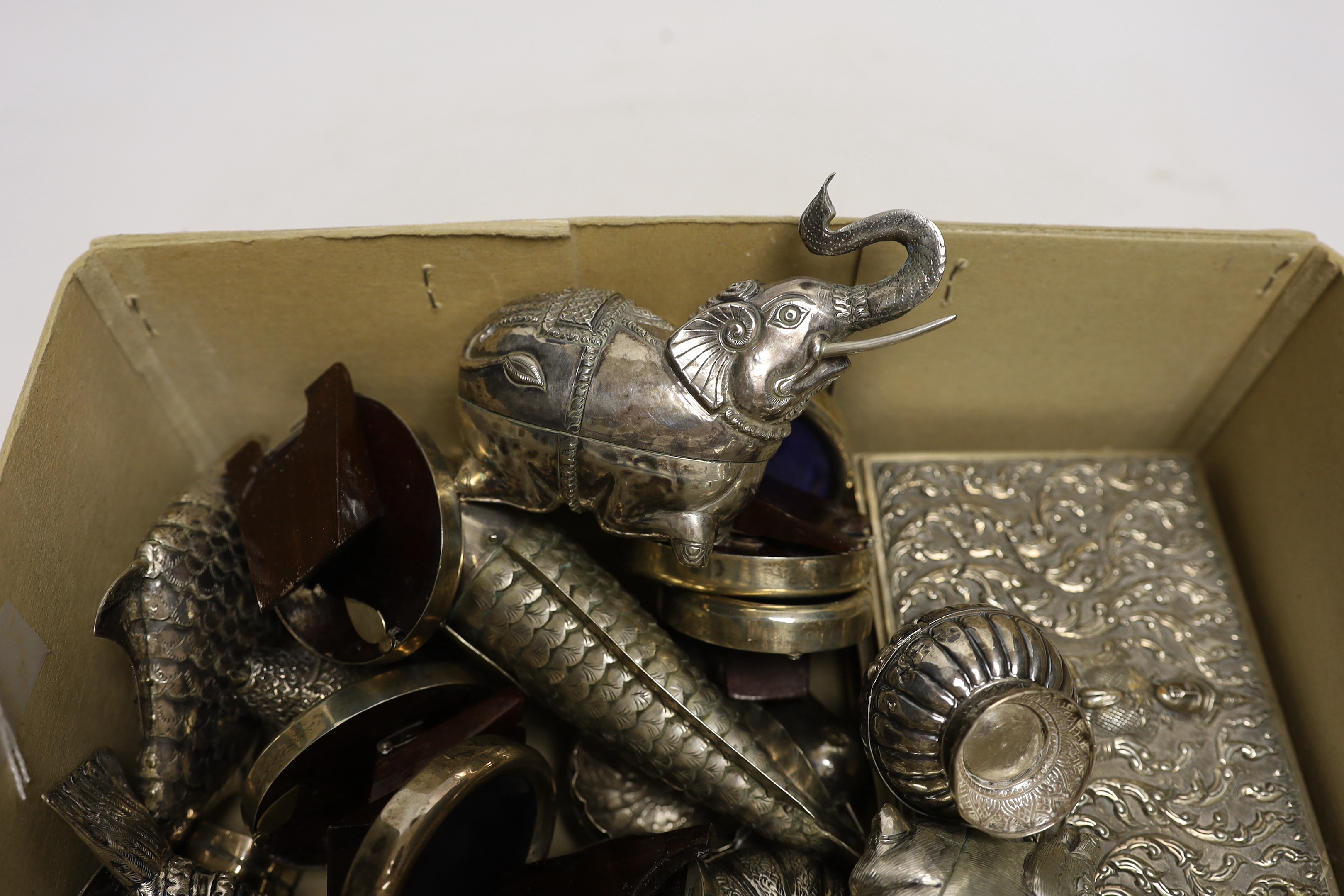 Sixteen assorted sterling mounted small photograph frames, largest 88mm and a quantity of assorted Thai boxes, mainly modelled as birds and other animals, a Thai repousse sterling cannister and cover and a Thai sterling